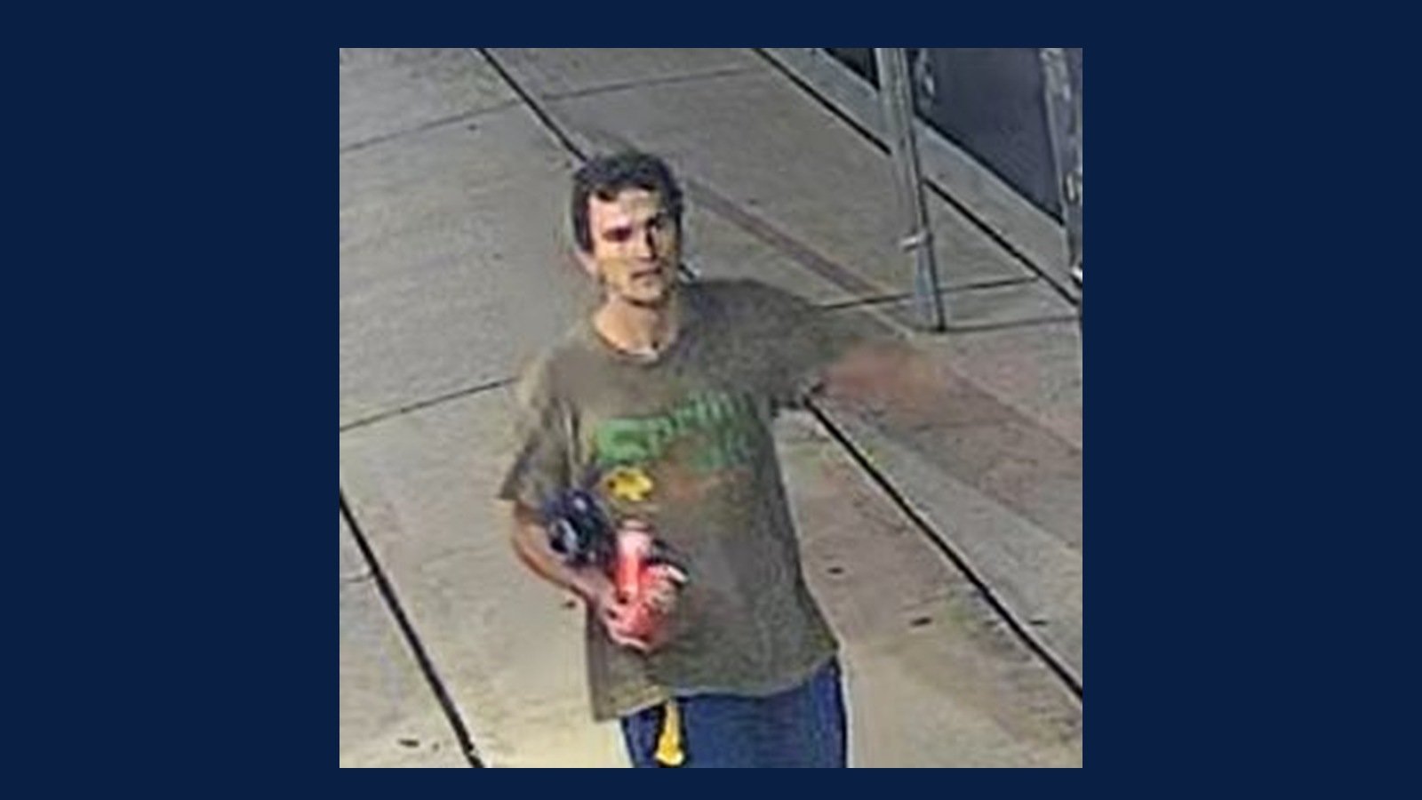Second Hoboken Police Department surveillance still of the same man, pushing a stroller