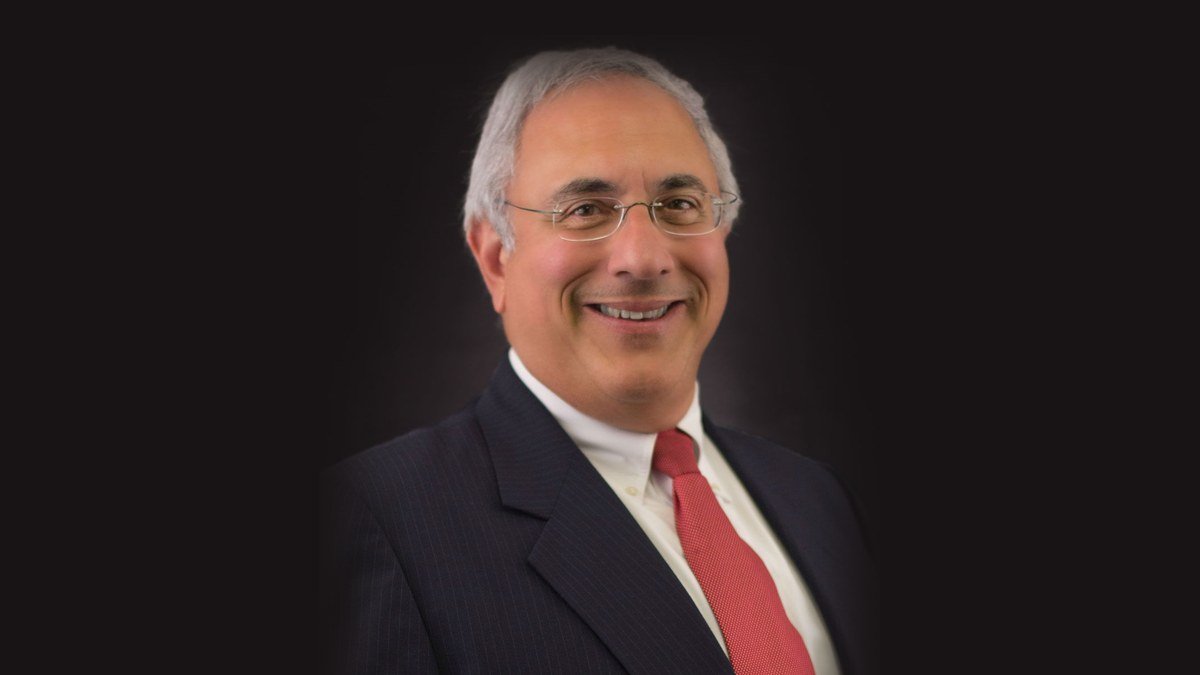 Donald Scarinci, managing partner of the law firm Scarinci Hollenbeck, in a suit and red tie