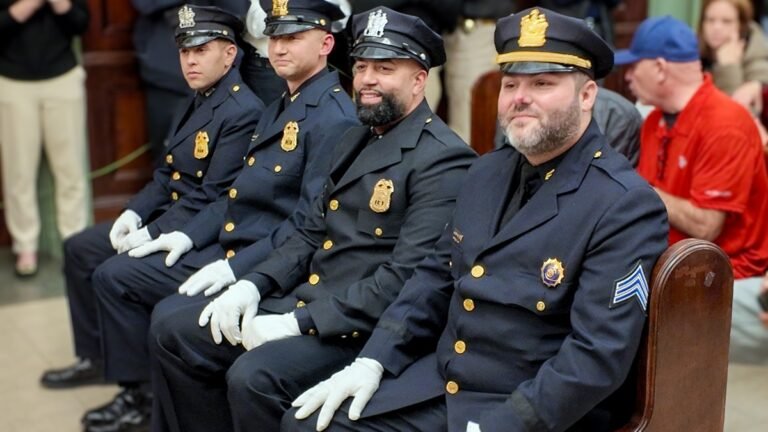 Promoted Hoboken, N.J. police officers in dress uniform at a City Hall promotion ceremony on Oct. 23, 2026.